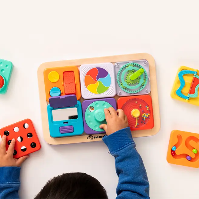 Child playing happily with wooden toys
